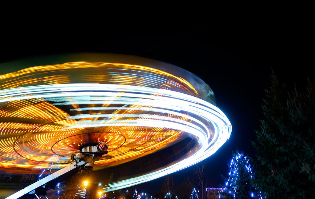 Carousel, tilt-a-whirl in motion, with extended exposure. At night in the amusement park.