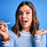 teenager holding her clear aligners